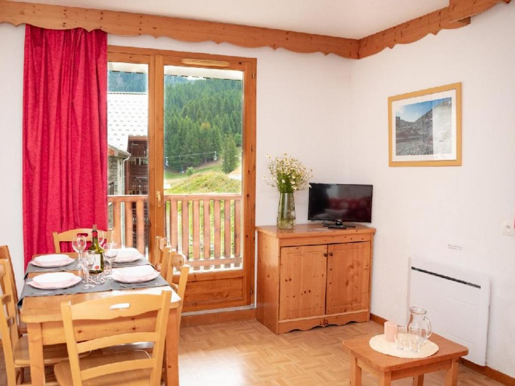 a dining room with a table and a television at Appartement Puy-Saint-Vincent, 3 pièces, 6 personnes - FR-1-504-145 in Puy-Saint-Vincent