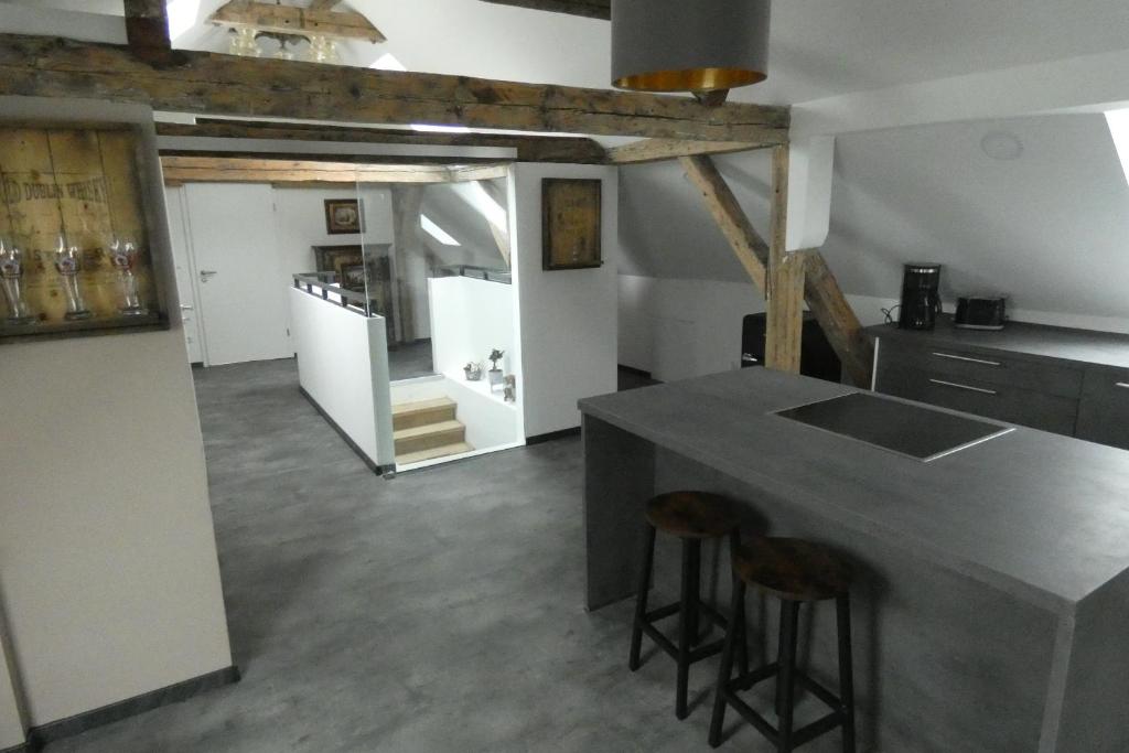 a kitchen with a counter and two bar stools at Holiday in Schwandorf in Bayern