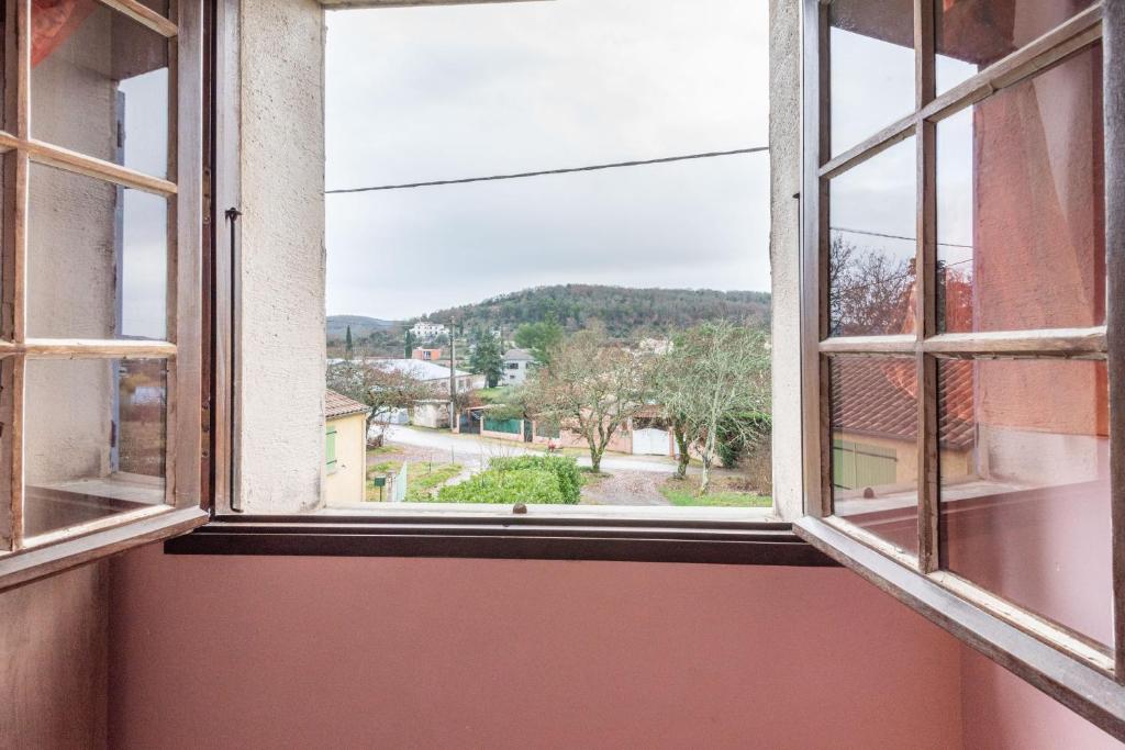 an open window with a view of a street at L&#39;Espedes in Ruoms