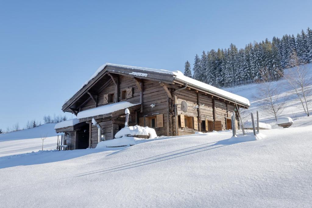 a log cabin in the snow with snow at IMMOBILIER DE MONTAGNE - LA COLLECTION - L'alpage in Saint-Gervais-les-Bains