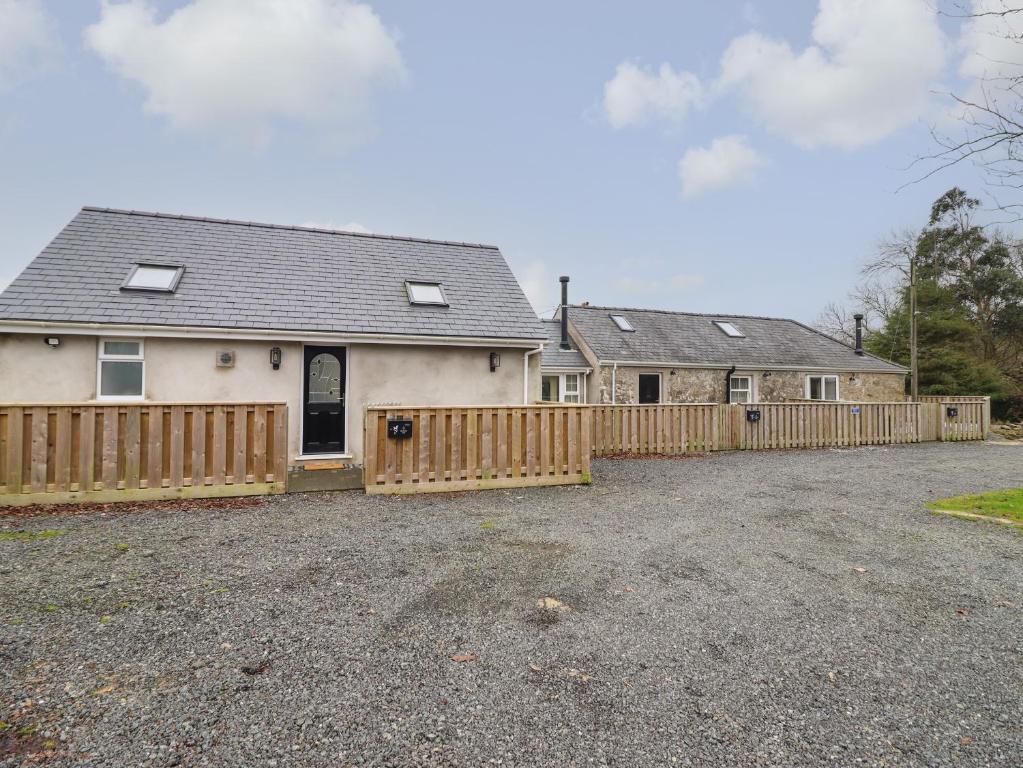 a house with a wooden fence in a driveway at 3 Mountain View in Llangefni