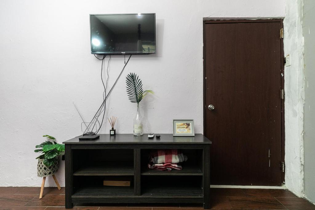 a black cabinet with a television on a wall at 1 BR, Dorado beach apartment 20% monthly discount in Dorado