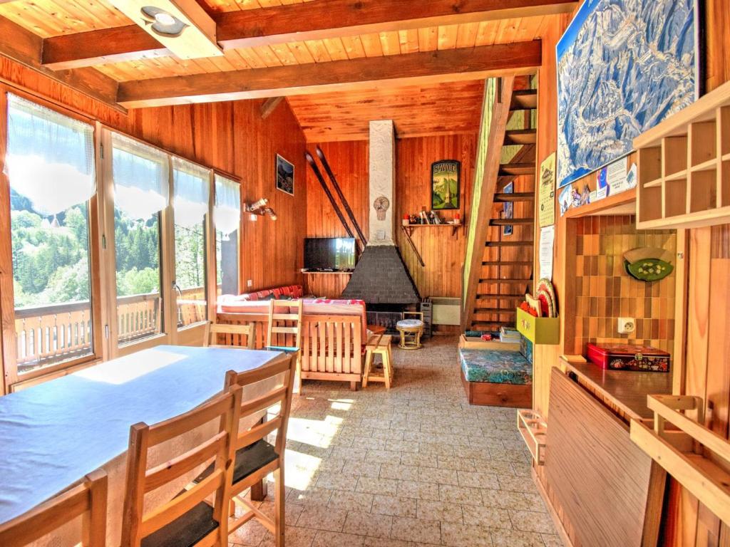 a dining room with a table and chairs and windows at Chalet Morzine, 4 pièces, 10 personnes - FR-1-524-6 in Morzine