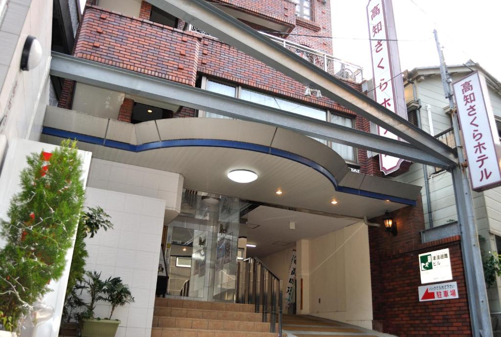 a building with a staircase in front of it at Kochi Sakura Hotel in Kochi