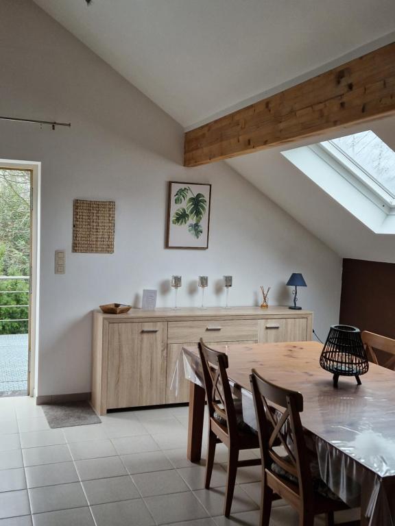 a kitchen with a table and chairs and a window at Studio Haras in Wavre