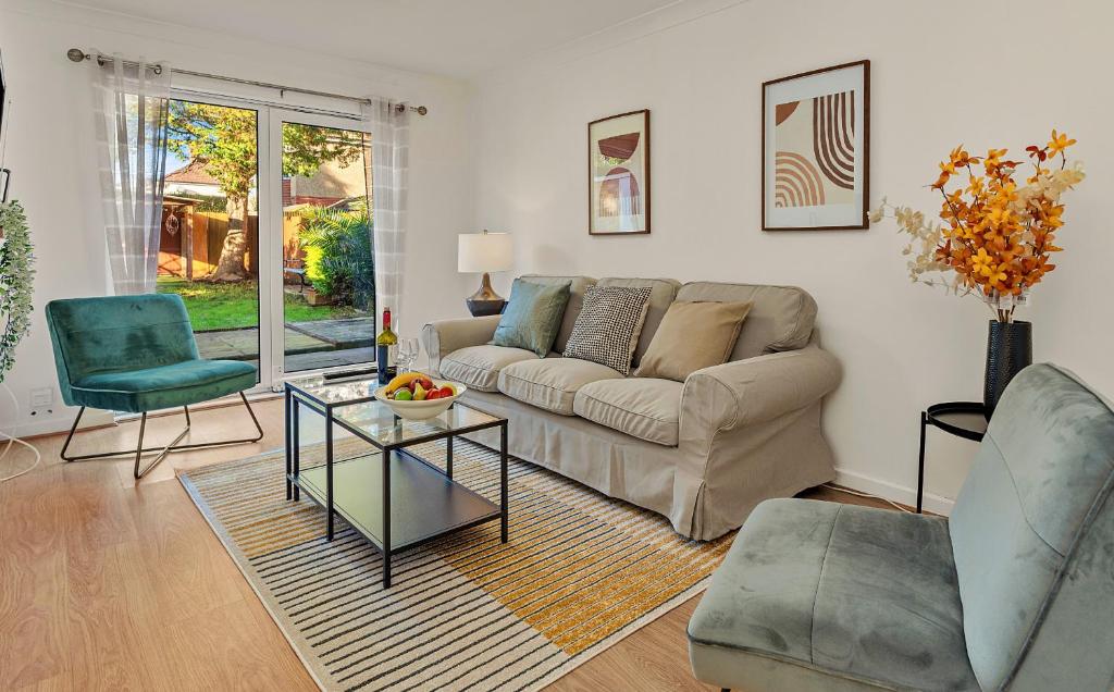 a living room with a couch and a table and chairs at Finest Retreats - White House Gardens in Southampton