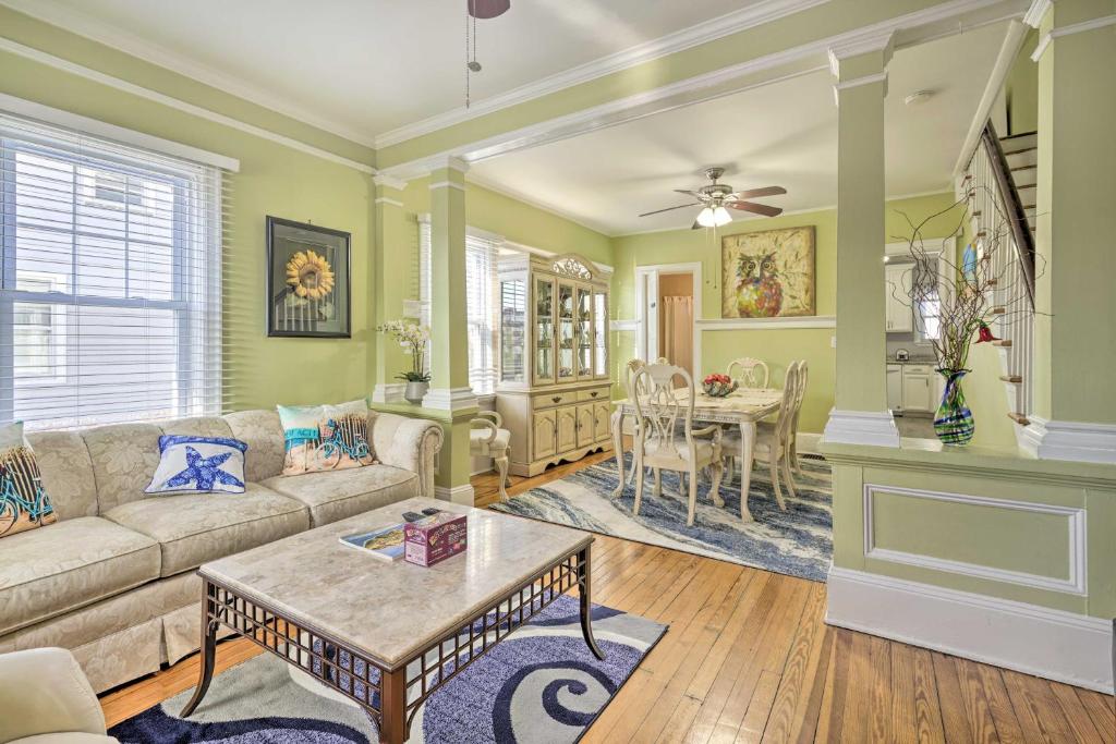 a living room with a couch and a table at Allenhurst Abode with Porch and Central Location! 