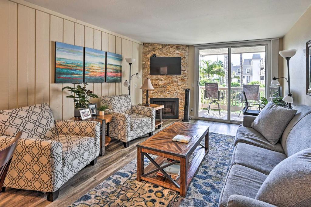a living room with two couches and a table at Deja Blue Beachfront Condo with Resort Pools! in Oceanside