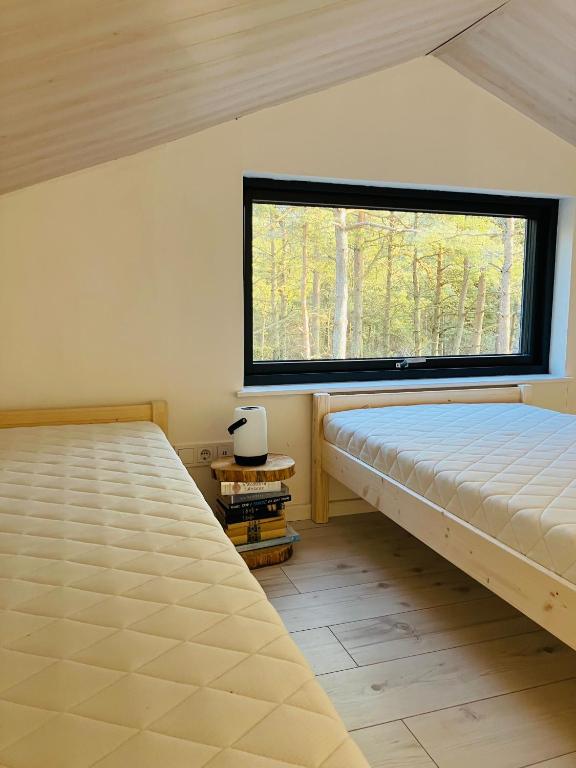 Postel nebo postele na pokoji v ubytování Forest House, Tiidu