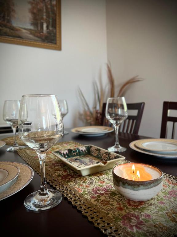 a table with a candle and wine glasses on it at Legacy 1930s in Prodromos