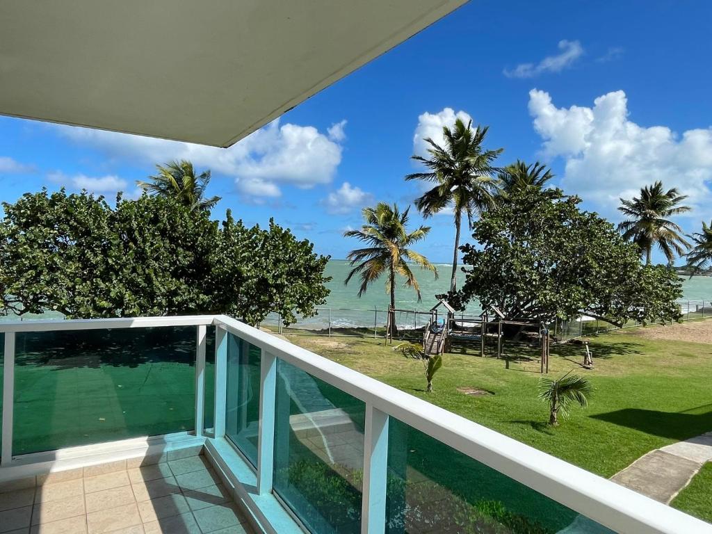 a balcony with a view of the ocean at Costa Mar Beach Front Apartment Whith Pool in Loiza