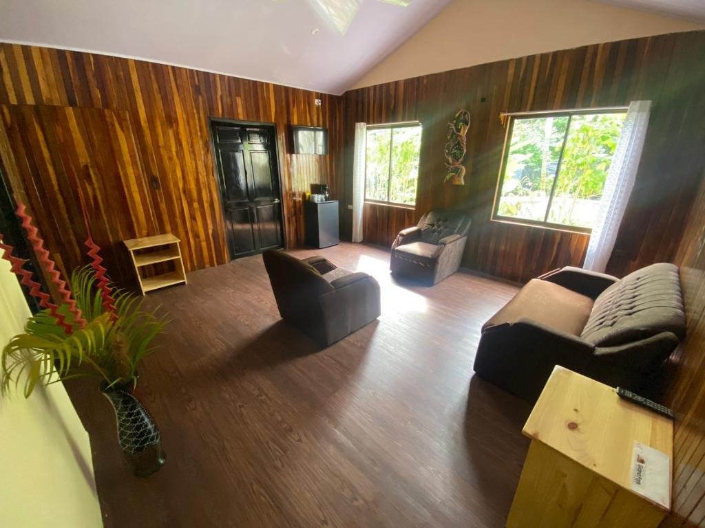 a living room with two couches and a table at Grand Park Manuel Antonio - Adults Only in Manuel Antonio