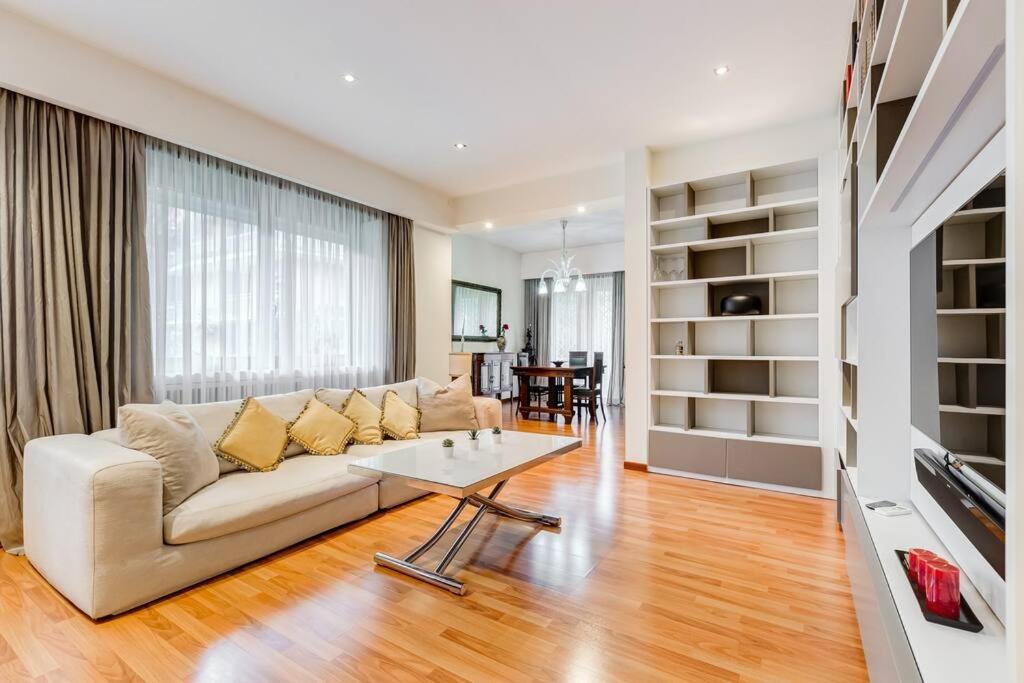 a living room with a couch and a table at Exclusive Apartment in Eur Lake in Rome