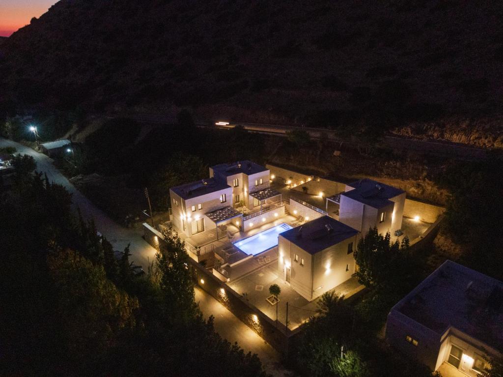 an aerial view of a house at night with lights at Matala Prime Villas in Matala