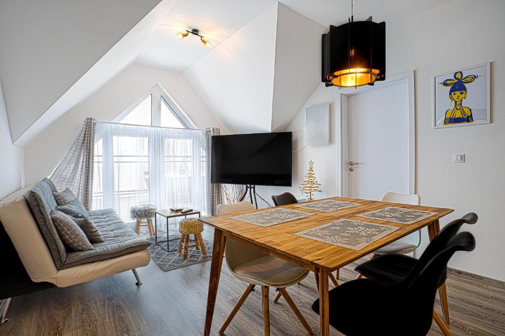 a dining room with a table and chairs at Mirabel Apartments Klinovec in Loučná pod Klínovcem