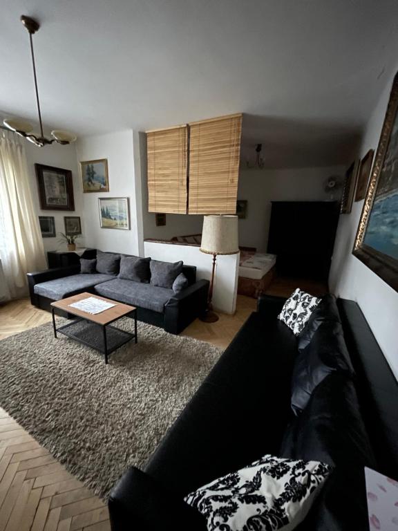 a living room with a couch and a table at Apartments & Restaurant Tkalcovsky dvur in Prague