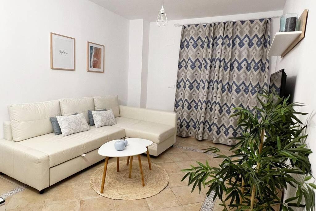 a living room with a white couch and a table at Ayamonte Vista Esuri Golf - 12 min to Isla Canela in Huelva