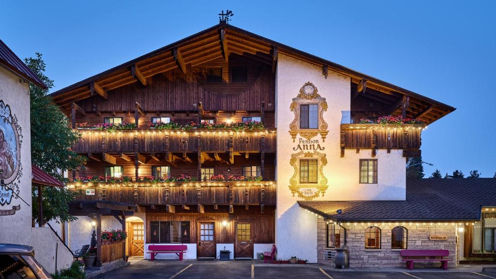 a building with a balcony with lights on it at Hotel Pension Anna in Leavenworth