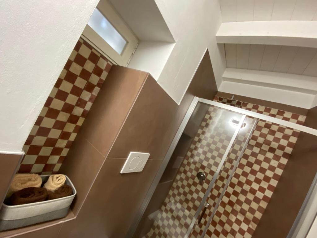 a bathroom with a shower with a checkered floor at Via Caputo 51 in Grottaglie