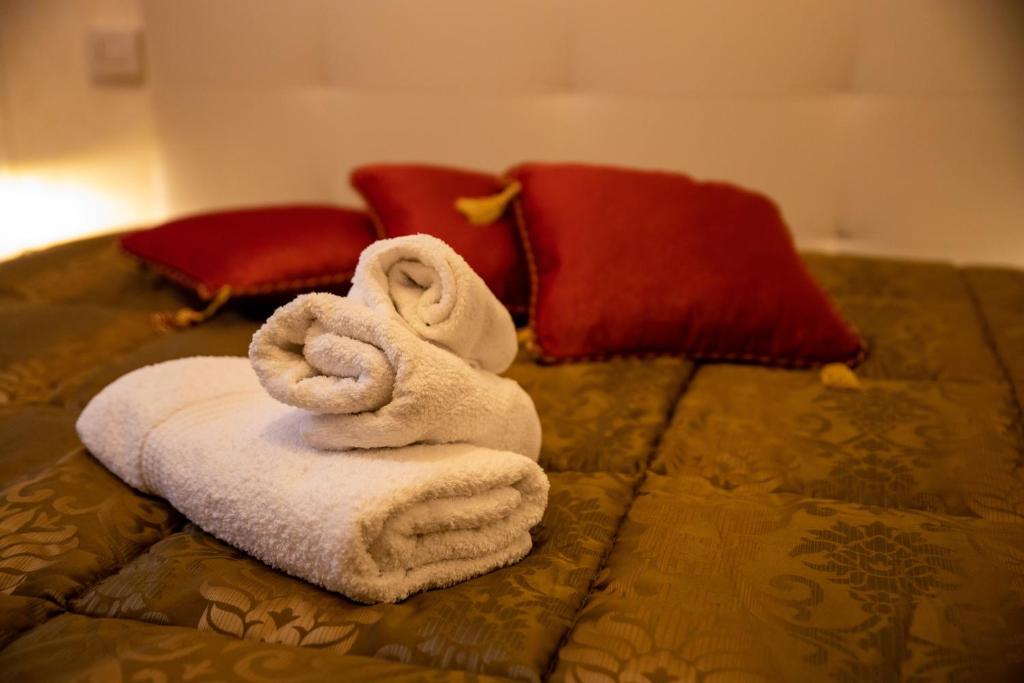 une pile de serviettes assises au-dessus d'un lit dans l'établissement VATICANO BED apartment, à Bari