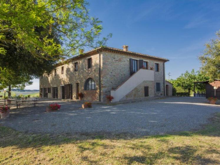 a large stone house with a staircase in front of it at Tenuta La Casetta in Casciana Terme