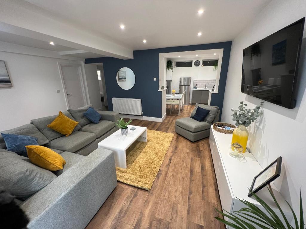 a living room with a couch and a table at Regent Apartment - Two bedroomed Holiday Flat in Ilfracombe
