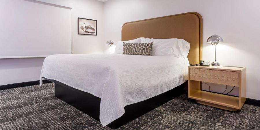 um quarto de hotel com uma cama grande e uma mesa de cabeceira em Wendover Nugget Hotel & Casino by Red Lion Hotels em West Wendover