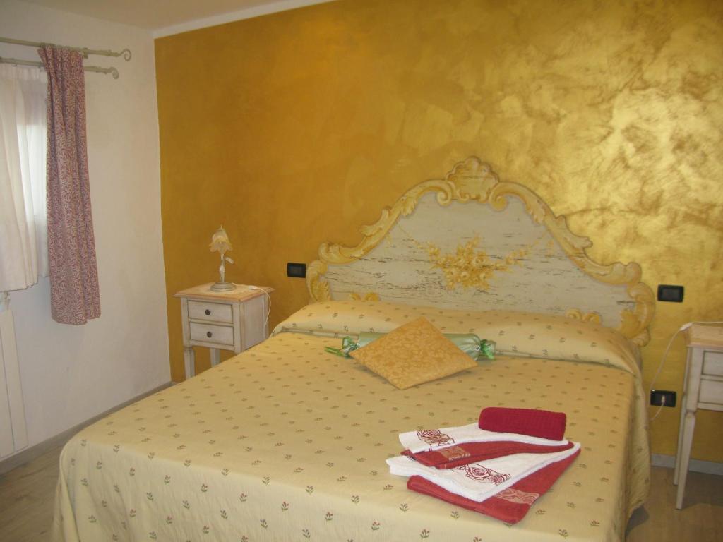 Postel nebo postele na pokoji v ubytování Relais Antico Borgo San Lorenzo