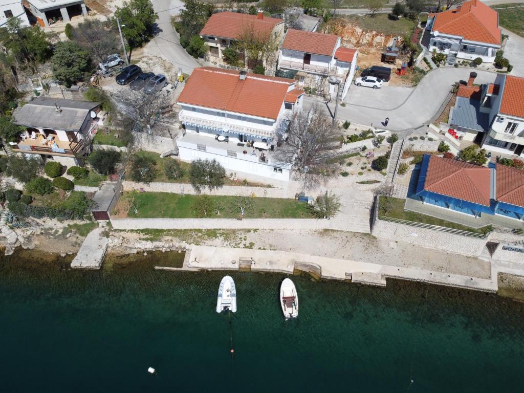 an aerial view of a house with a boat in the water at Apartman Gaga in Kruševo