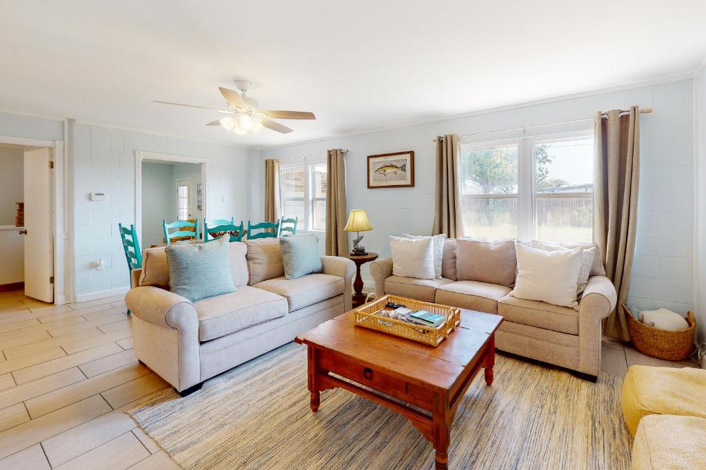 a living room with two couches and a coffee table at The Saltbox in Padre Island