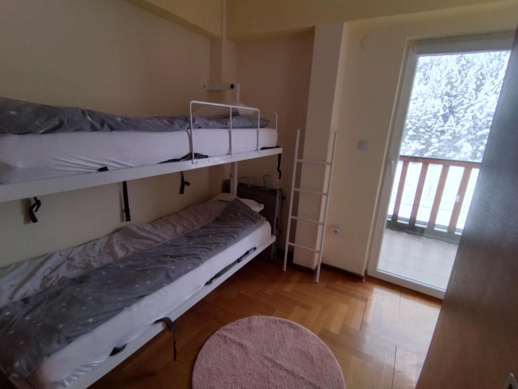 a bedroom with two bunk beds and a window at Ljubica in Brzeće