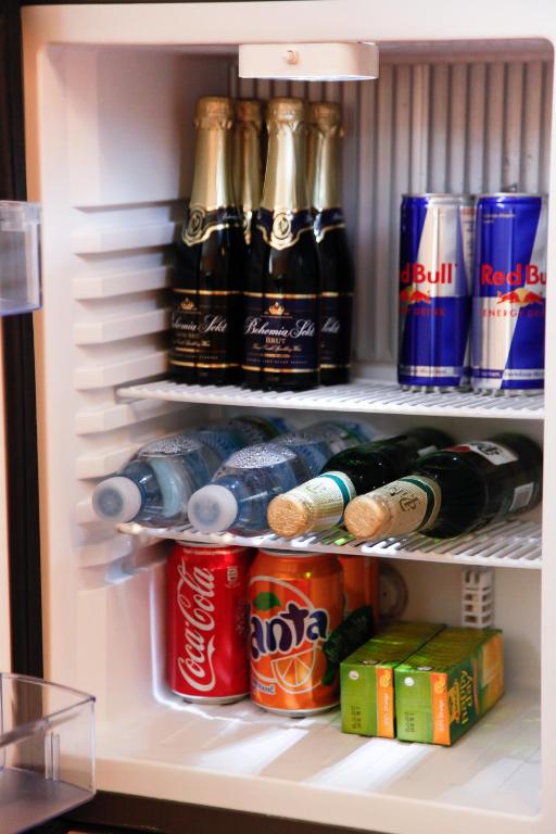 a refrigerator filled with bottles and cans of soda at Pension Dvořák in Karlovy Vary