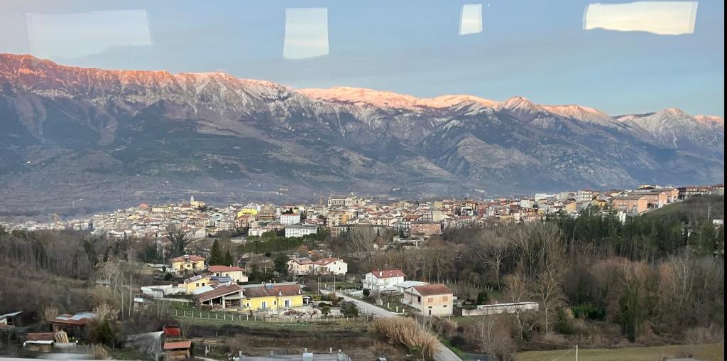 a city in front of a mountain range with houses at Casa vacanza Pratola in Pratola Peligna