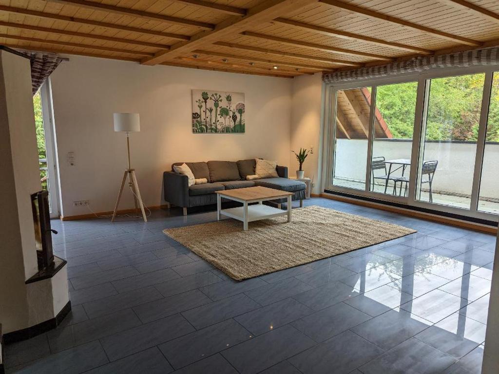 a living room with a couch and a table at Ferienwohnung am Schönberg - Ebringen in Ebringen