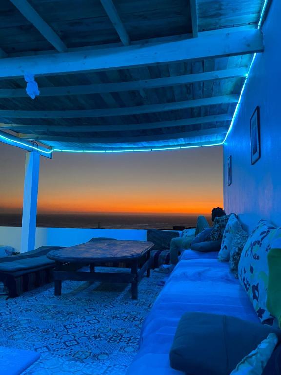 a living room with a couch and a table at EL Faro Surfstay in Tamri