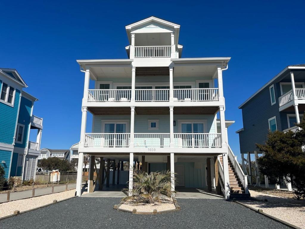 a large white building with a white balcony at 1030 Ocean home in Holden Beach