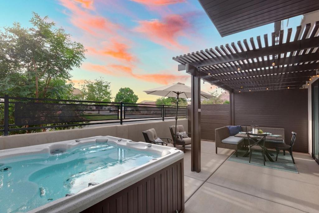 a hot tub on a patio with a table and chairs at Ocotillo Spring Resort 44 Sky Fire Private Brand-New Home, Private Hot Tub, and Community Pool in Santa Clara