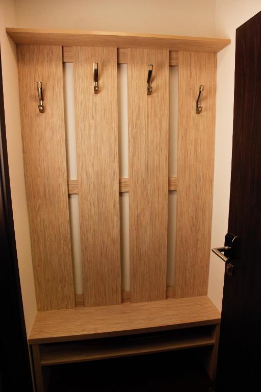 a wooden closet with four panels of wood at Pension Dvořák in Karlovy Vary
