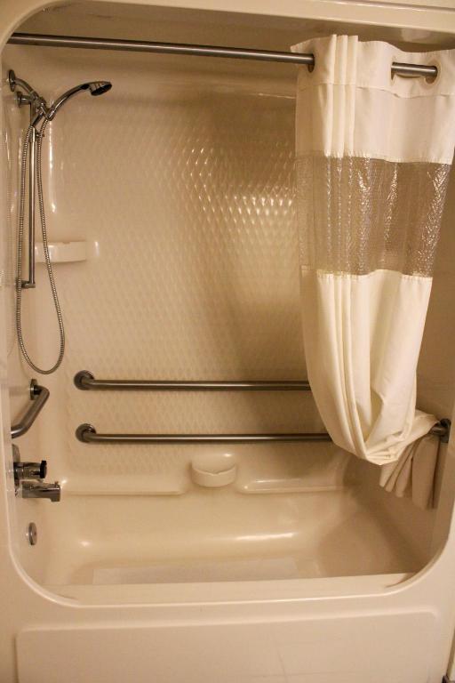 a bathroom with a shower and a toilet at Sleep Inn in Bend