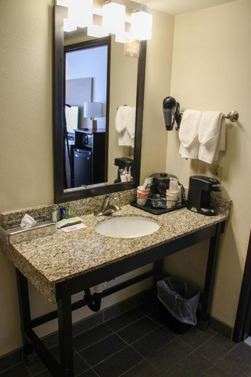 a bathroom with a sink and a mirror at Sleep Inn in Bend