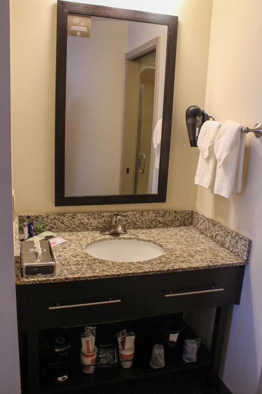 a bathroom with a sink and a mirror at Sleep Inn in Bend