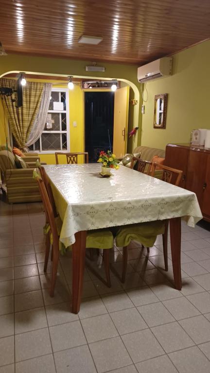 una mesa de comedor con un mantel blanco. en Casa amueblada en Cipolletti Rio Negro en Cipolletti