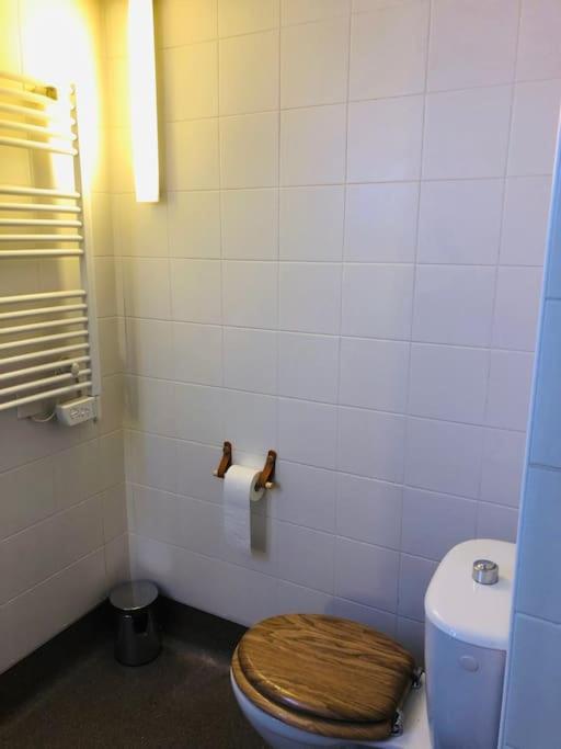 a bathroom with a toilet with a wooden toilet seat at Studio - Centre Ville - free parking in Montpellier