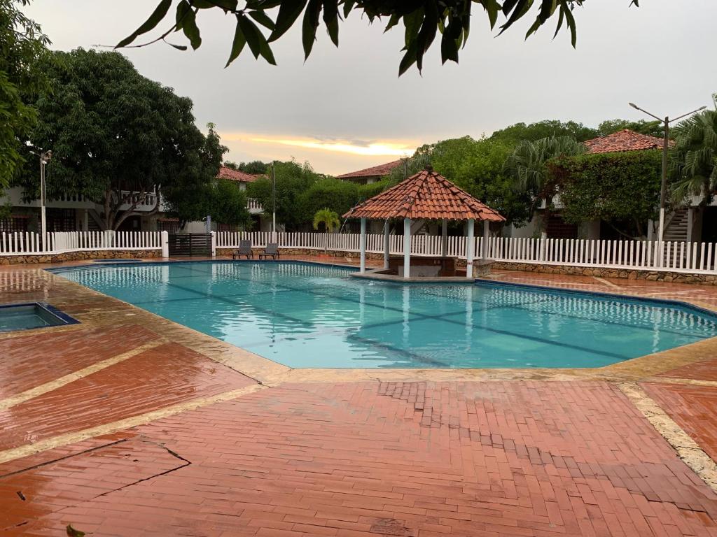 a large swimming pool with a gazebo at Cabañas Mar de Coveñas in Coveñas