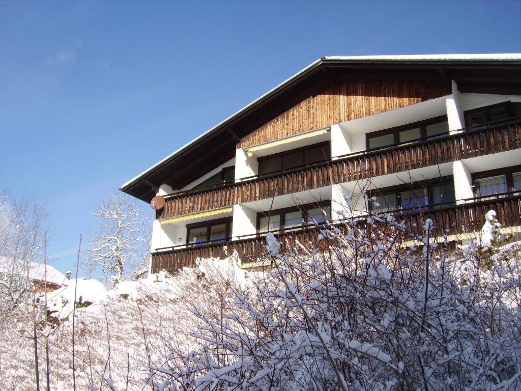 a building on top of a snow covered hill at Alpencottage Bad Aussee in Bad Aussee