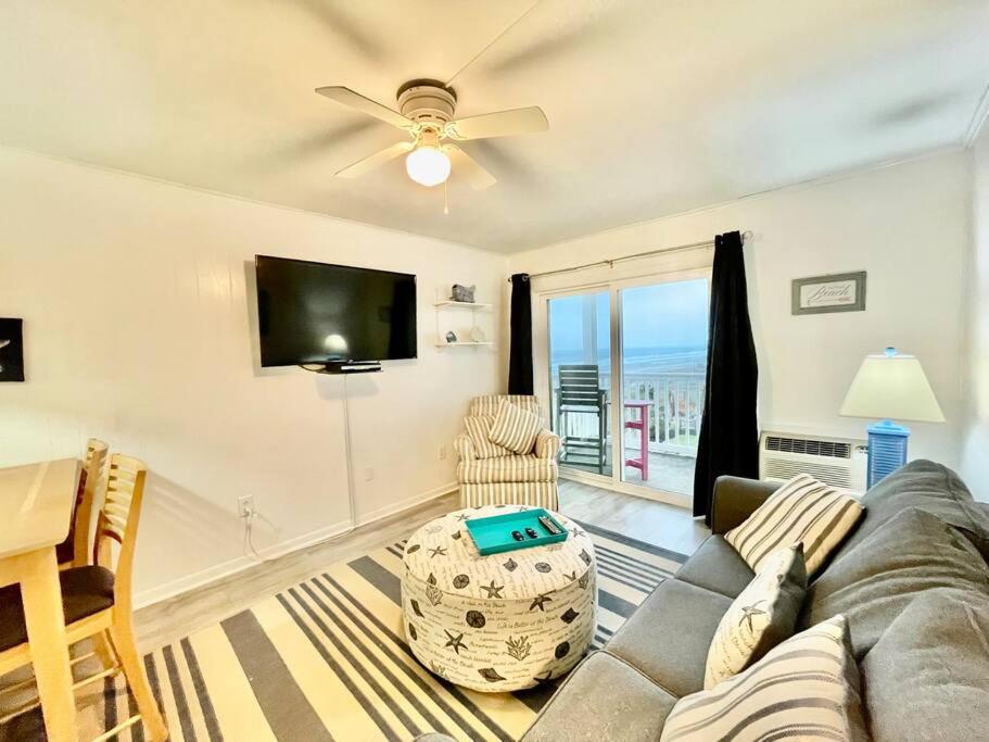 a living room with a couch and a flat screen tv at Lovely 2 bedroom condo with ocean view 304 in Myrtle Beach
