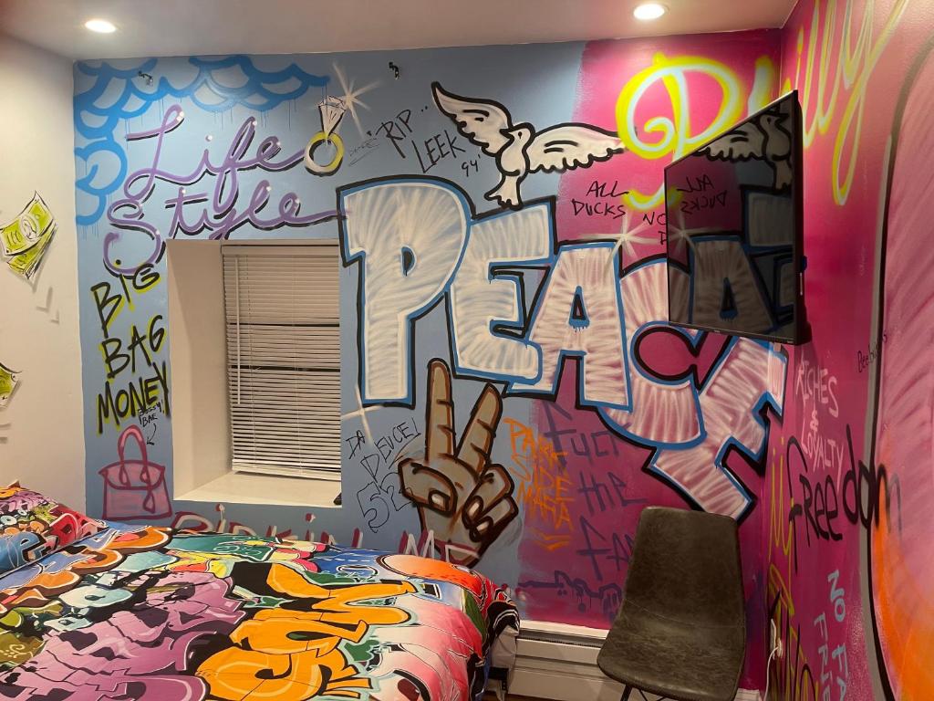 a bedroom with graffiti on the wall and a bed at Art Deco Graffiti Suite in Philadelphia