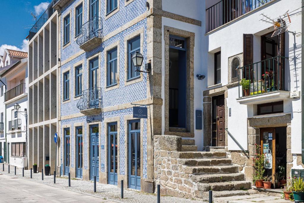 a blue and white building on a street at Pensão Luisinha by Casas com Estória Boutique Houses in Santa Comba Dão