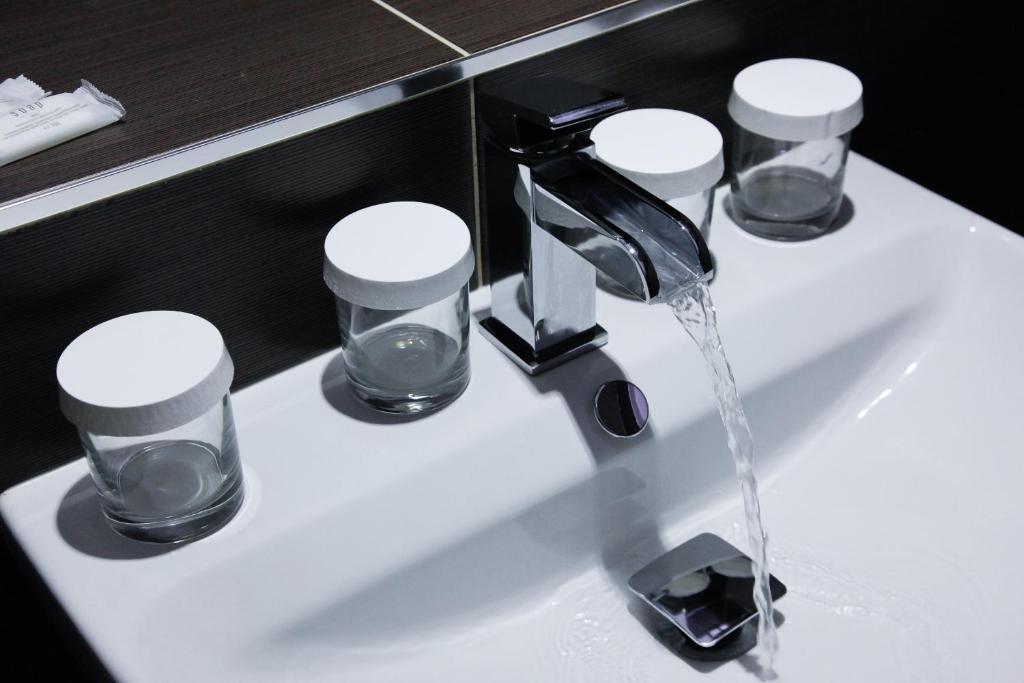 a bathroom sink with water coming out of a faucet at Pension Dvořák in Karlovy Vary