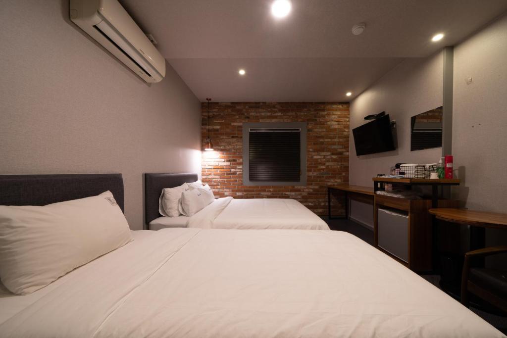 Postel nebo postele na pokoji v ubytování No25 Hotel Yeonsan